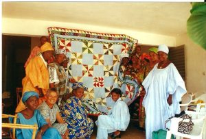 Some of the women of the Patchwork Project. Ami is in the blue-and-white dress and head wrap, at the bottom of the photo.