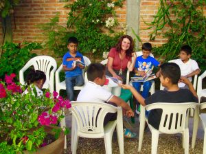 Director Linda Curran with students in the school's courtyard