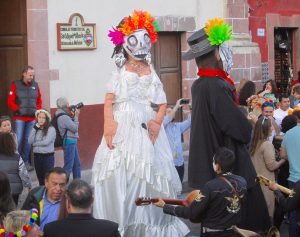 Marty (Martha Cooper), center left, photographing a Day of the Dead wedding celebration near the Jardin in SMA